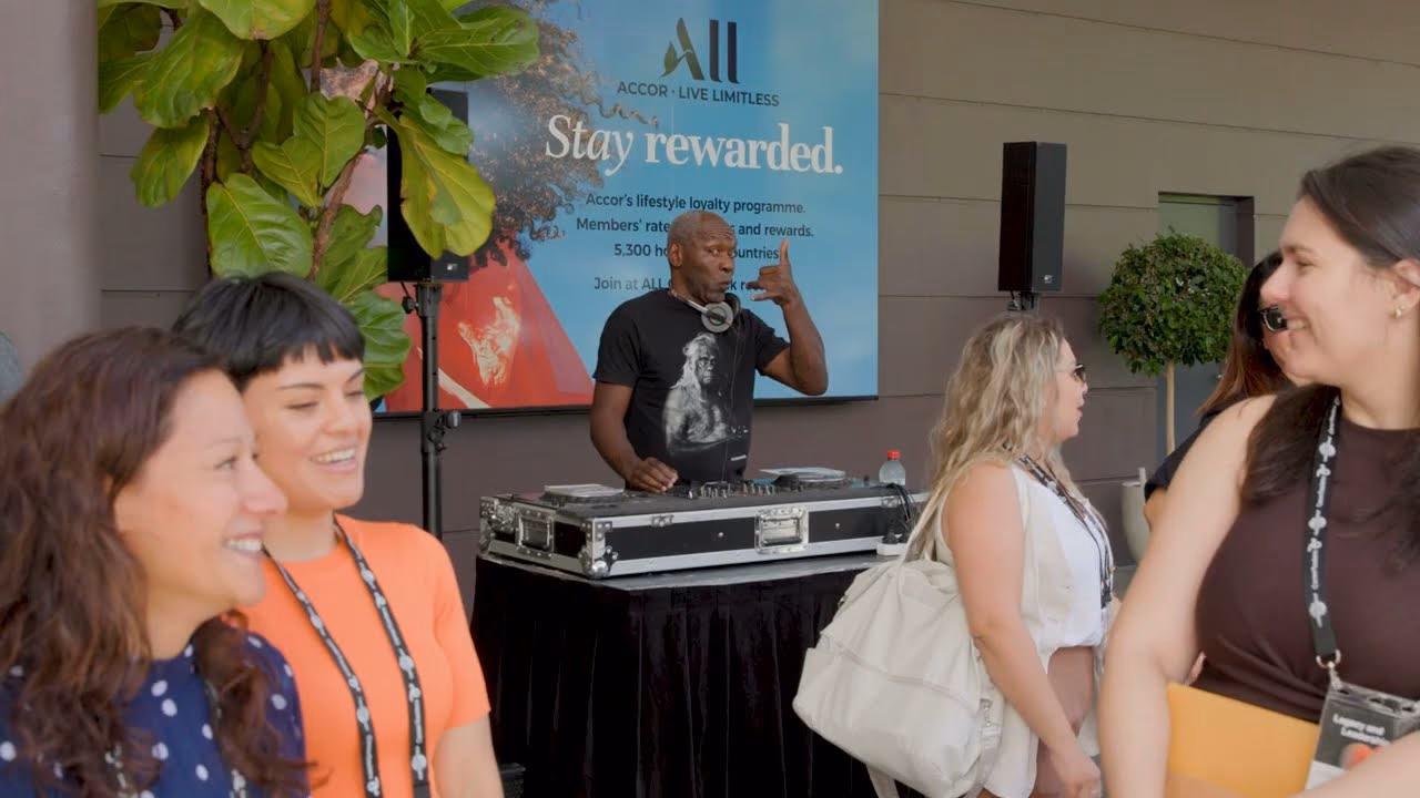 Interns mingling at LDI 2026 while a DJ plays.