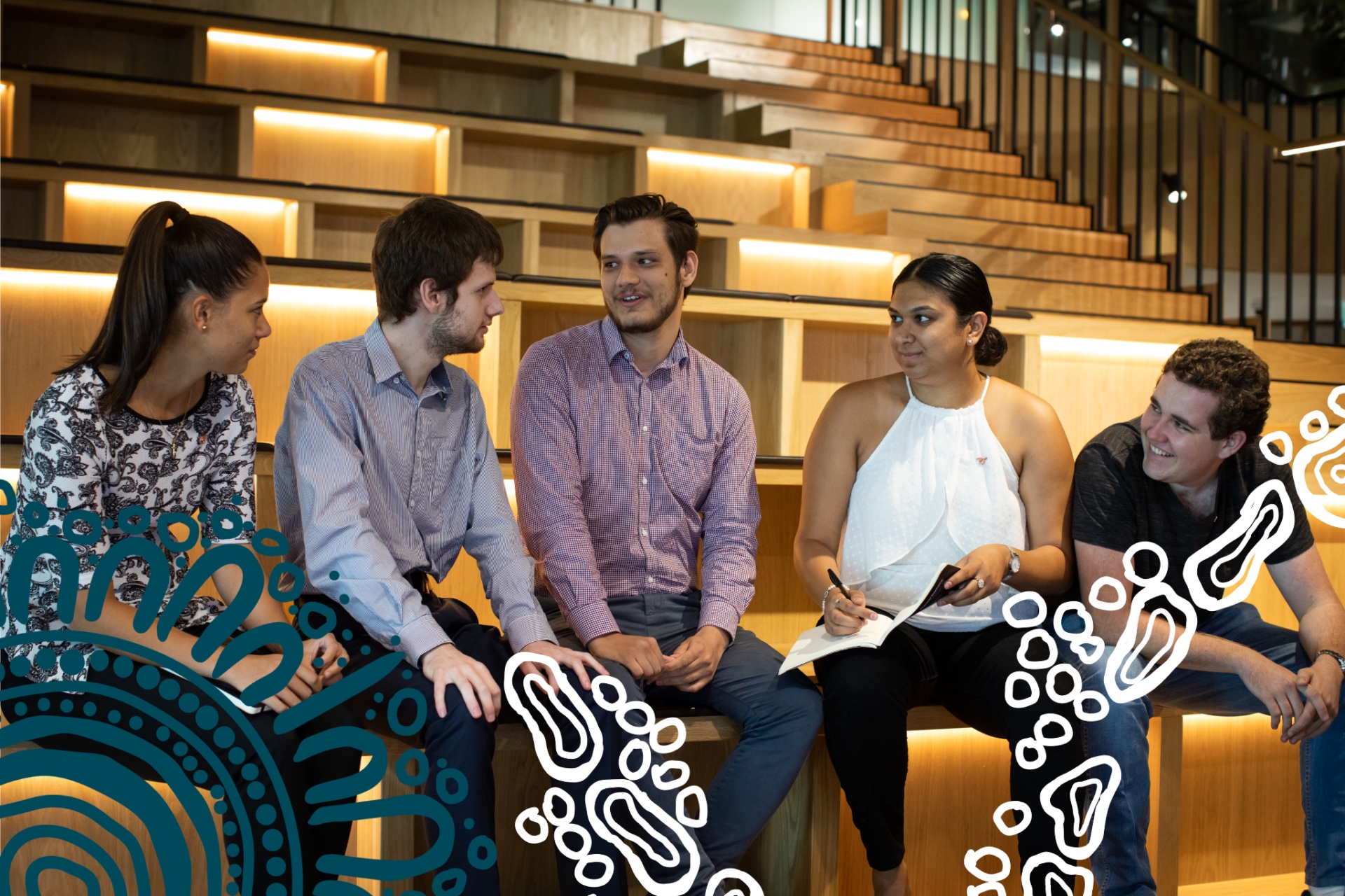 A small group of CareerTrackers interns sitting together and talking on an amphitheatre staircase, with First Nations dot-art graphics overlaid.